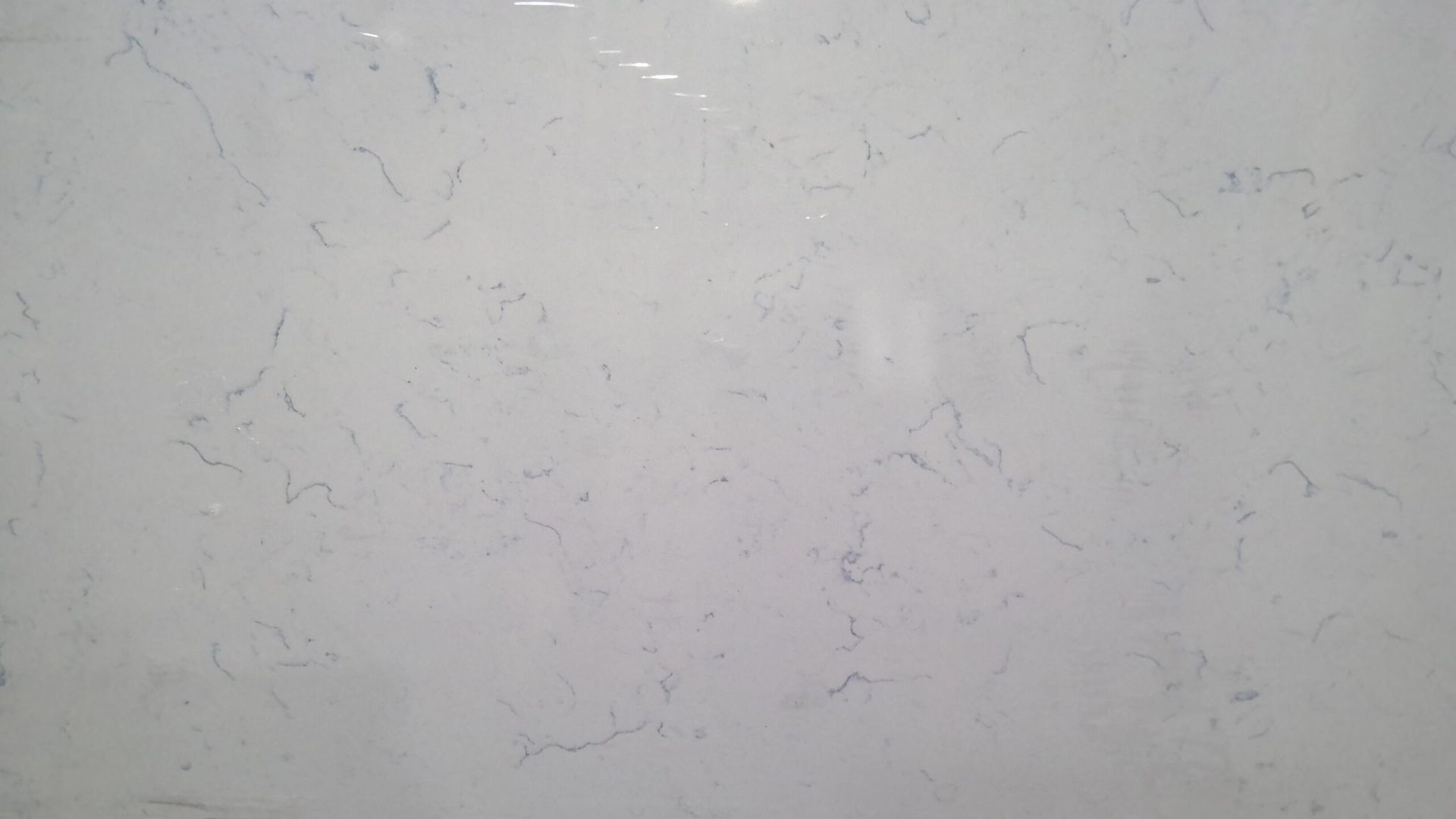 White countertop with subtle blue veining.