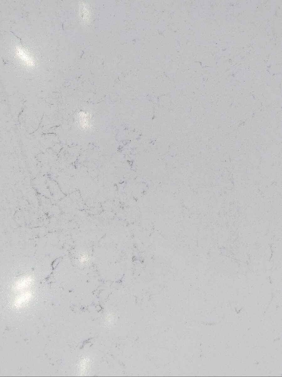 White countertop with grey marbling and light reflections.