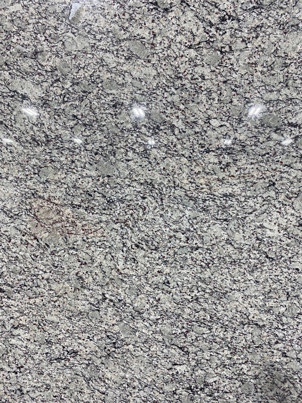 Gray and white granite countertop with small black flecks.