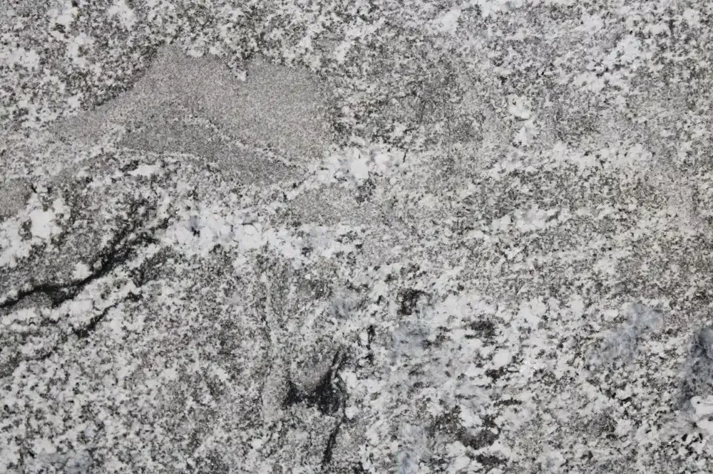 Close-up of a gray and white granite countertop, with speckled and patterned texture.