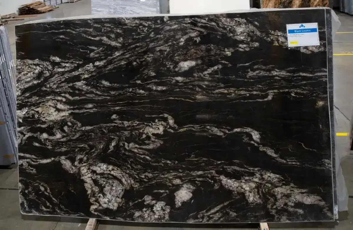 Large slab of black granite with swirling white and gray patterns.