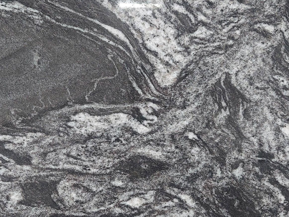 Black and white granite countertop with swirling patterns.