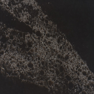 Close-up of dark countertop with a speckled texture, resembling dark stone.