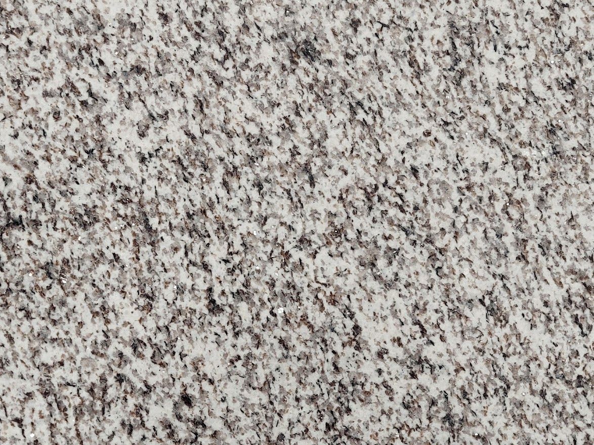 Close-up of a gray and white speckled granite surface.