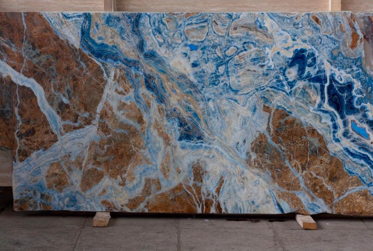Large slab of marble with swirling blue and brown patterns.