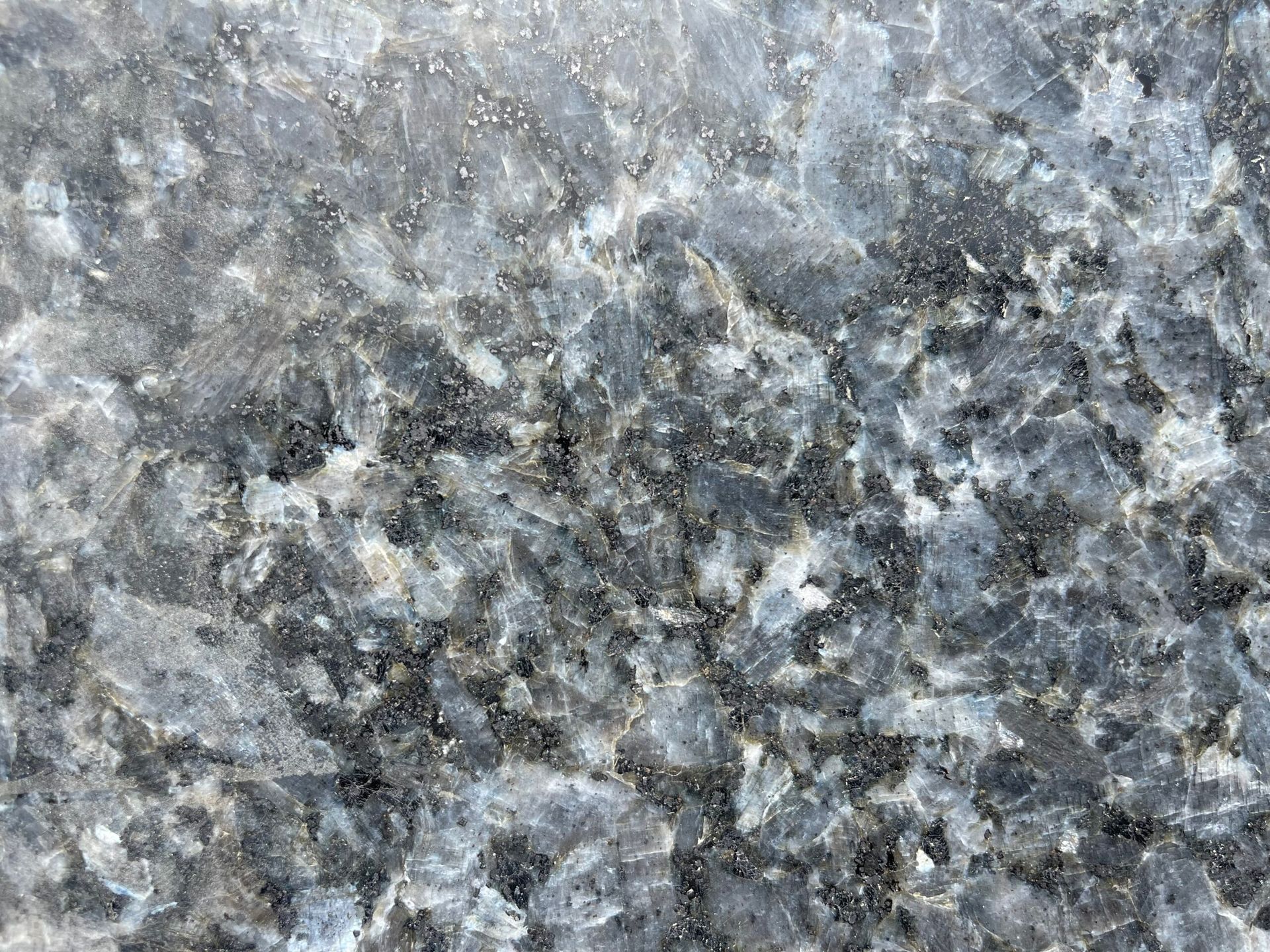Gray and blue granite with speckled and marbled patterns.