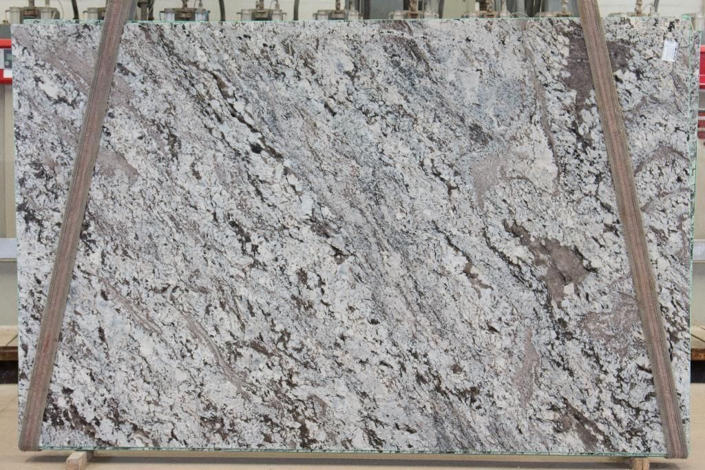 Large granite slab, mostly white with gray and brown veining.