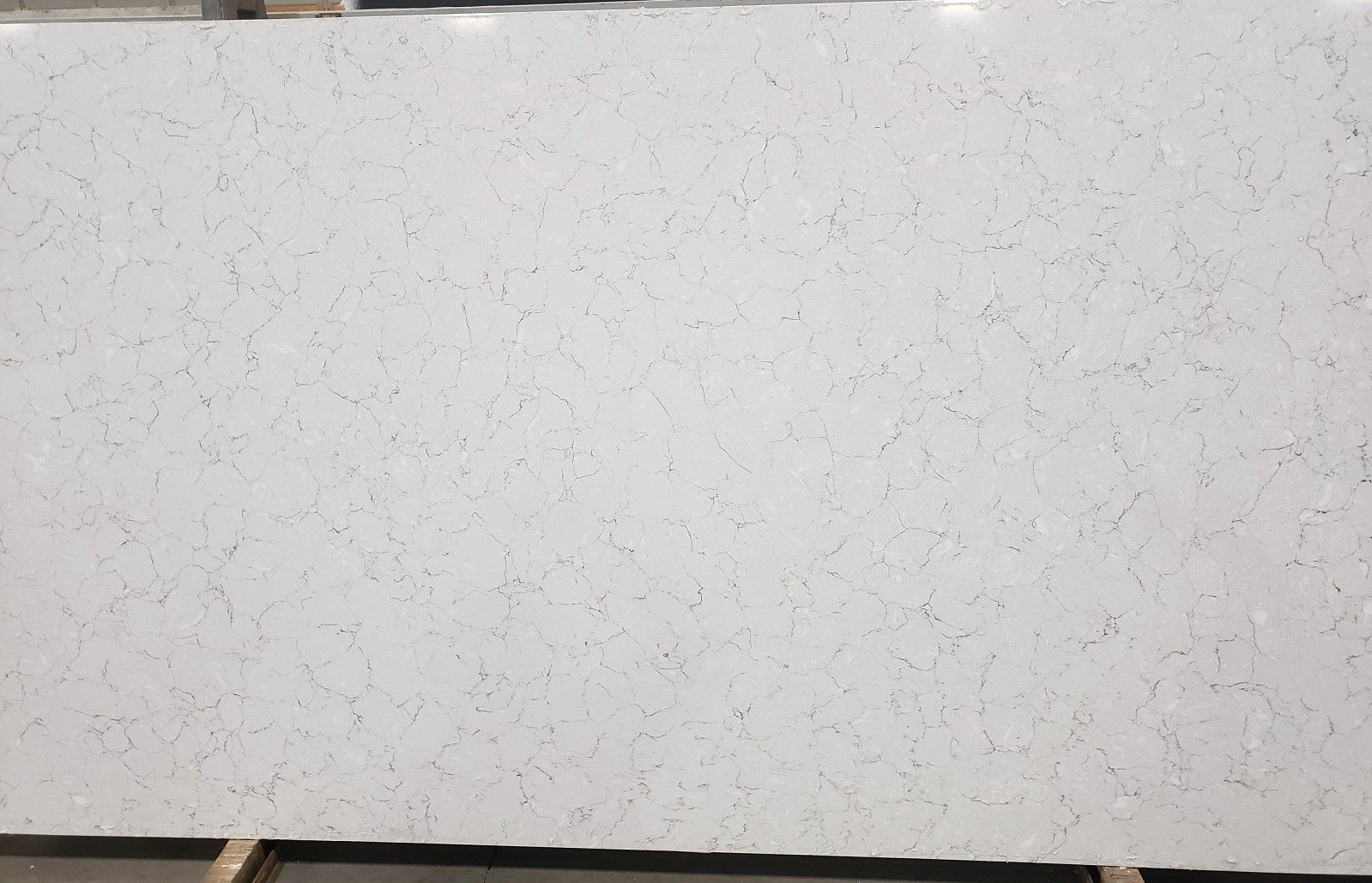 White countertop slab with speckled dark gray/black pattern.