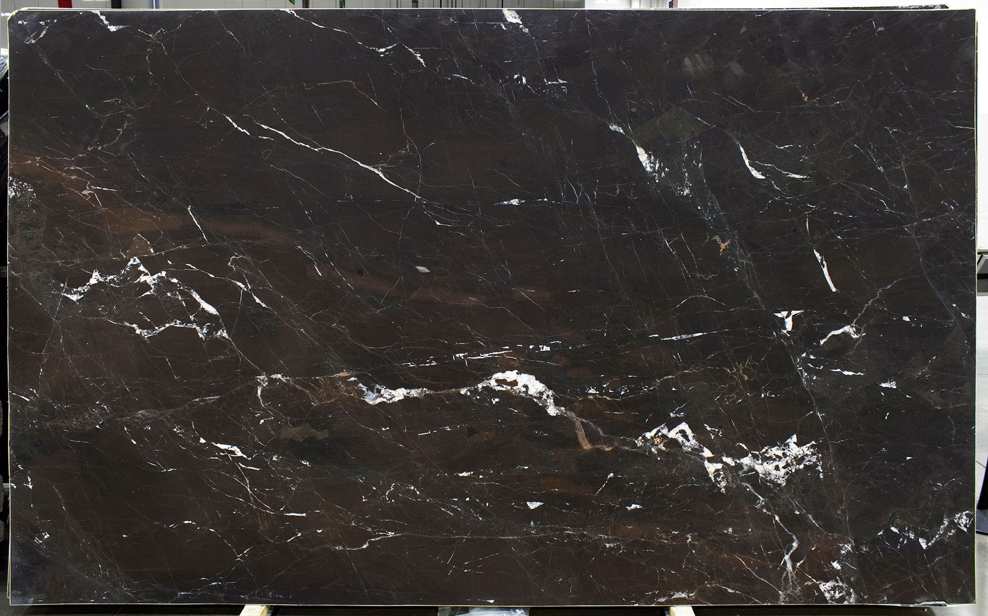 Dark brown marble slab with white veining.
