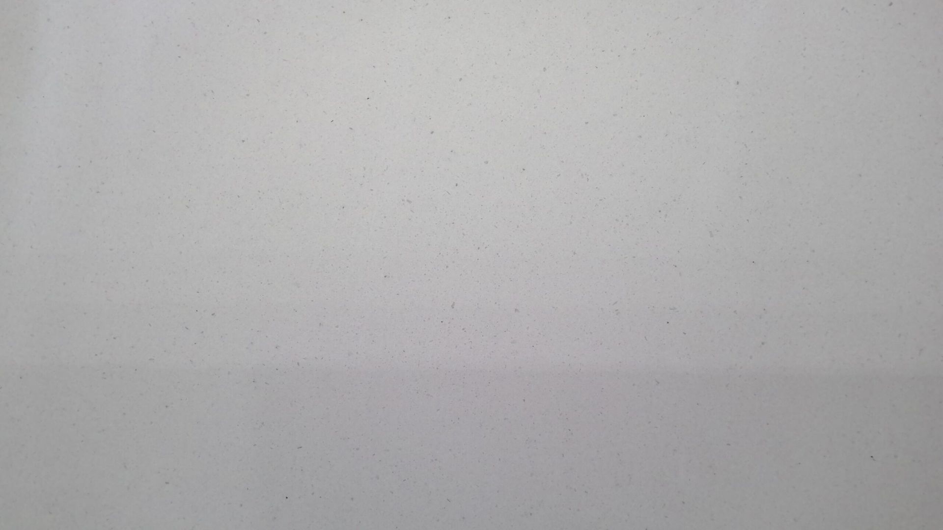 Plain, white wall with subtle texture.