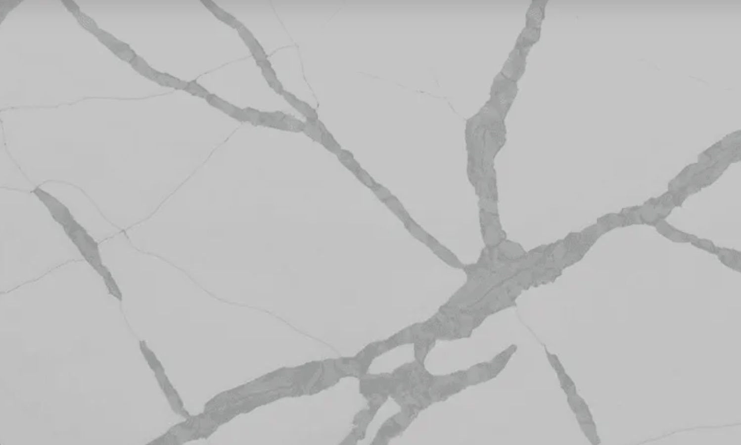 Gray and white quartz countertop with veining pattern.