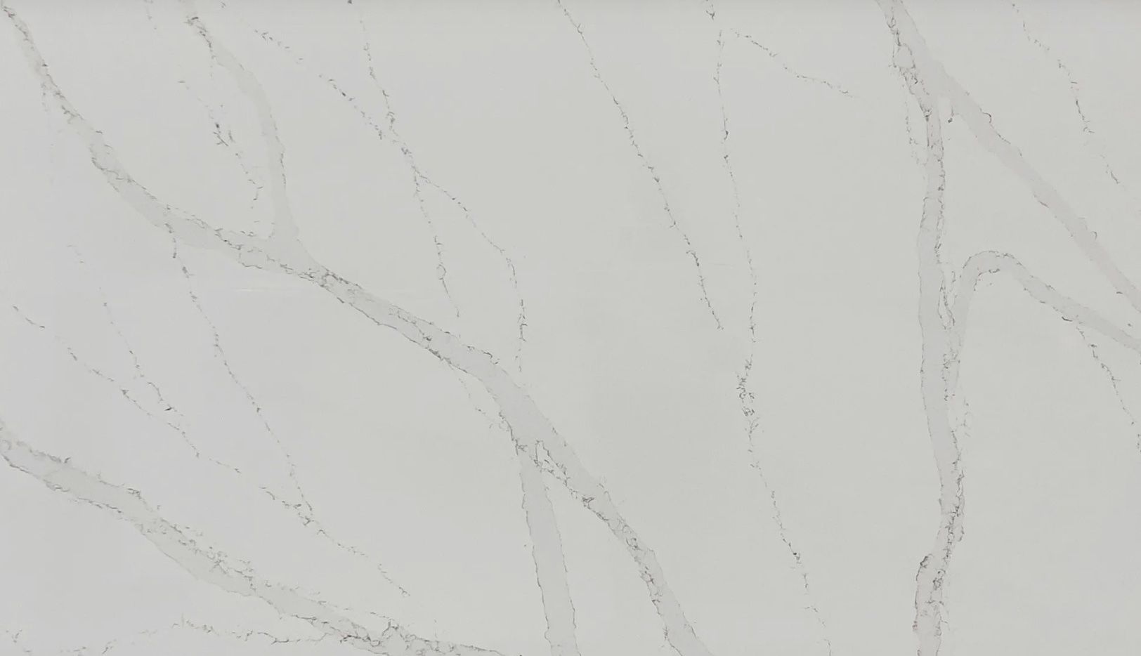 White marble countertop with gray veining throughout the surface.