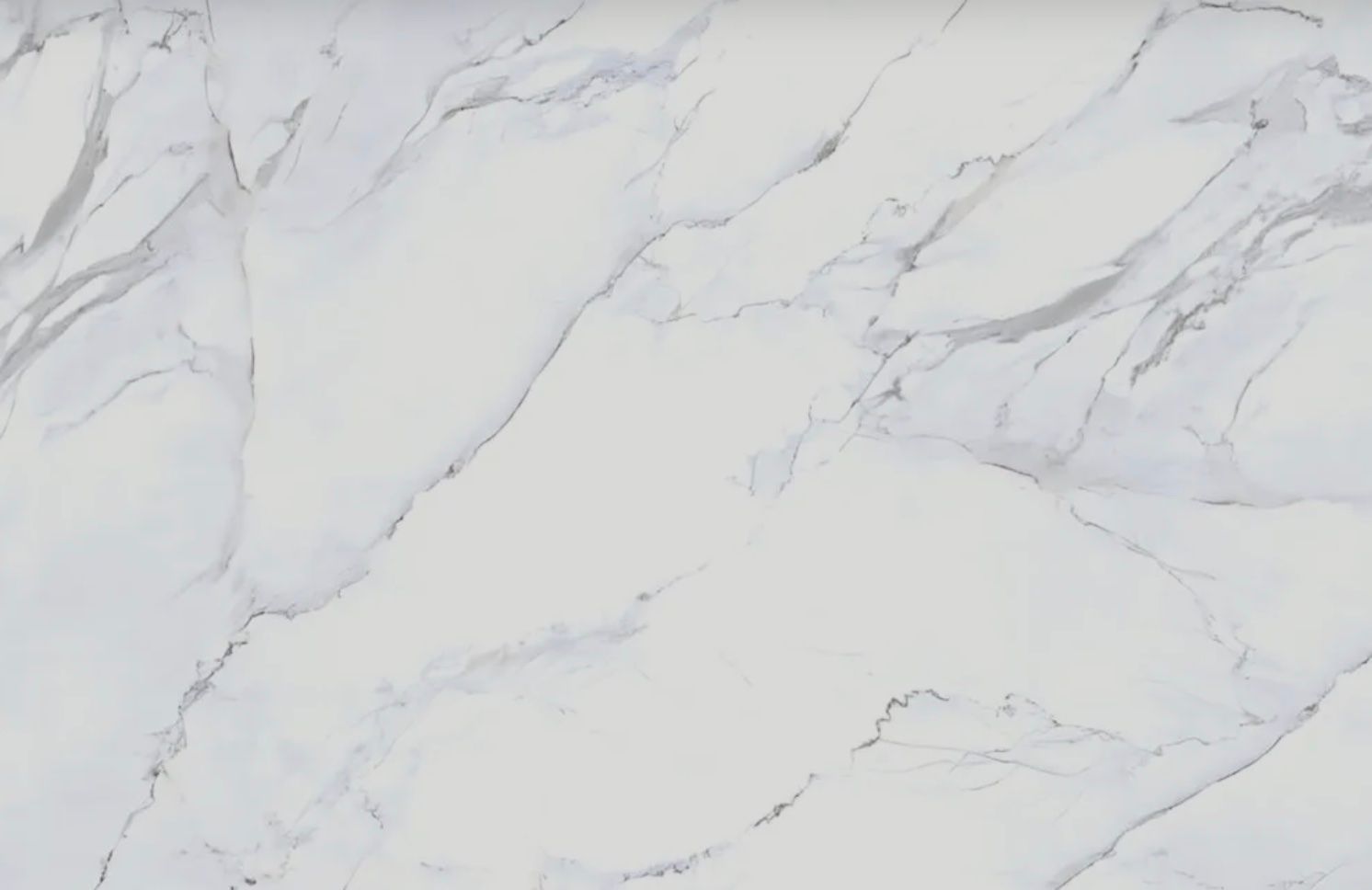 White countertop with gray veining, resembling marble.