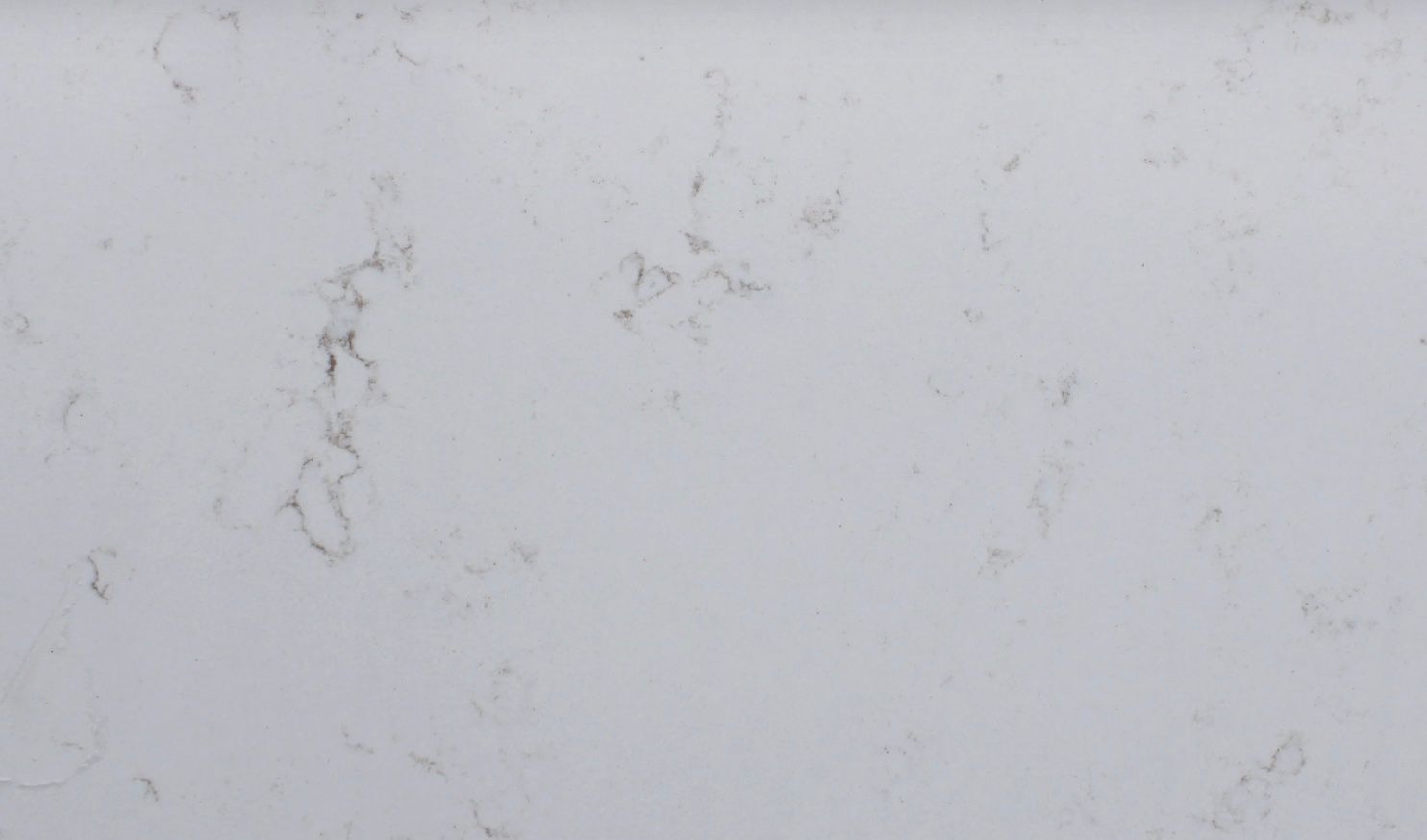 White quartz countertop with subtle gray and brown veining.