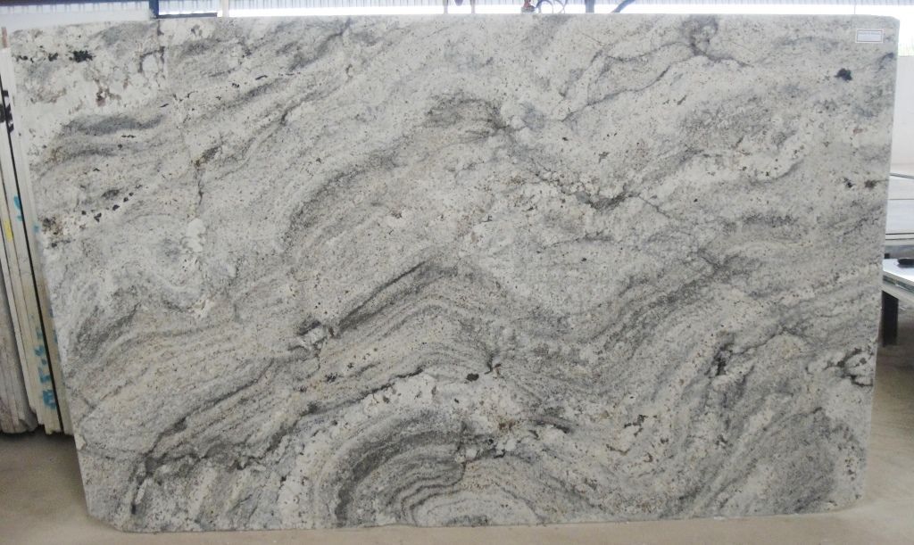 Large slab of white granite with swirling gray veins.