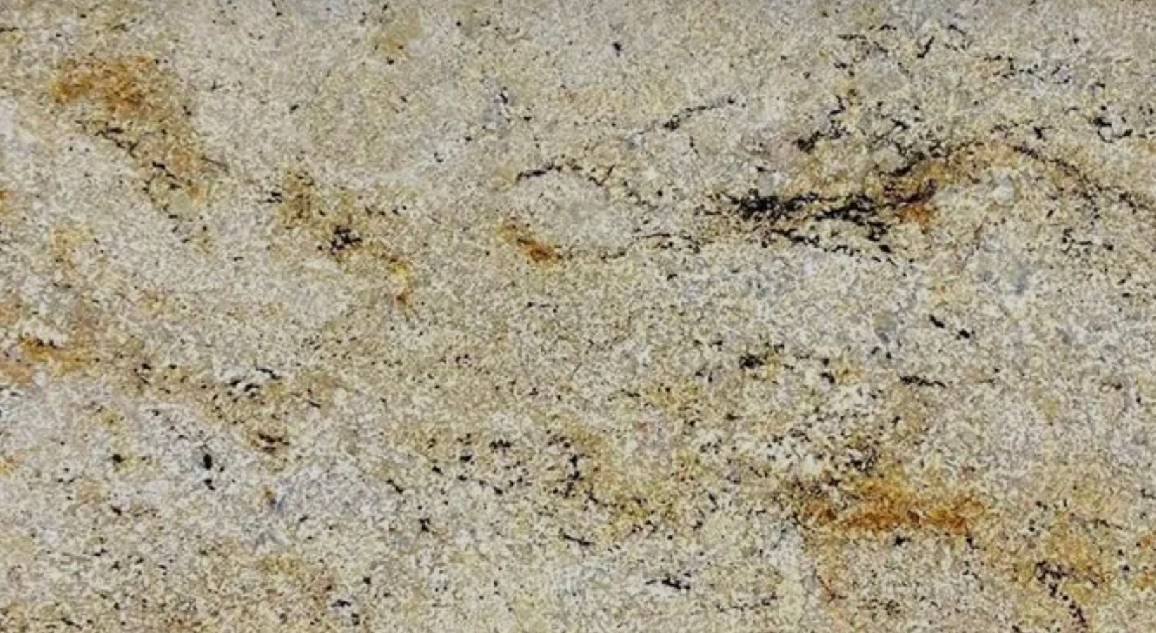 Granite countertop with beige and gold swirls and black speckles.