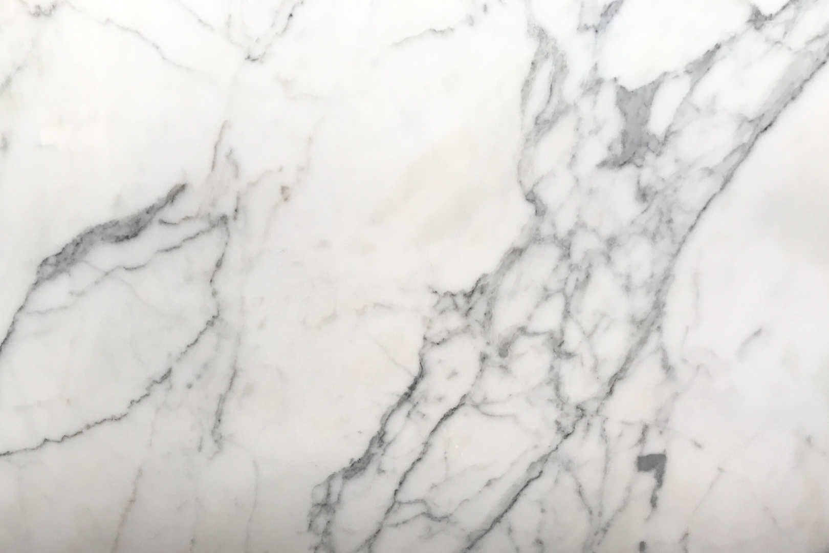 White marble surface with gray veining patterns.