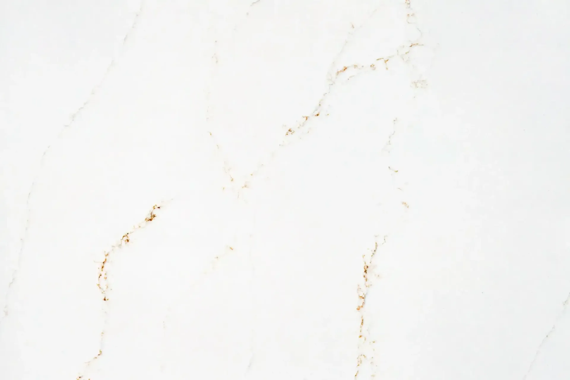 White marble surface with gold veining.
