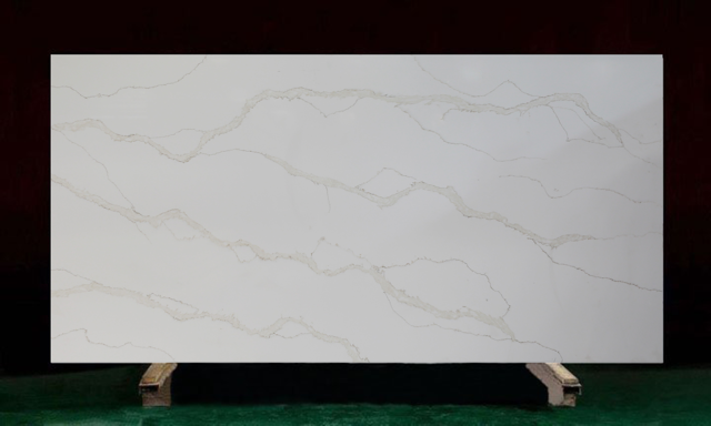 White countertop with gold veining, displayed on a wooden stand against a dark red background.