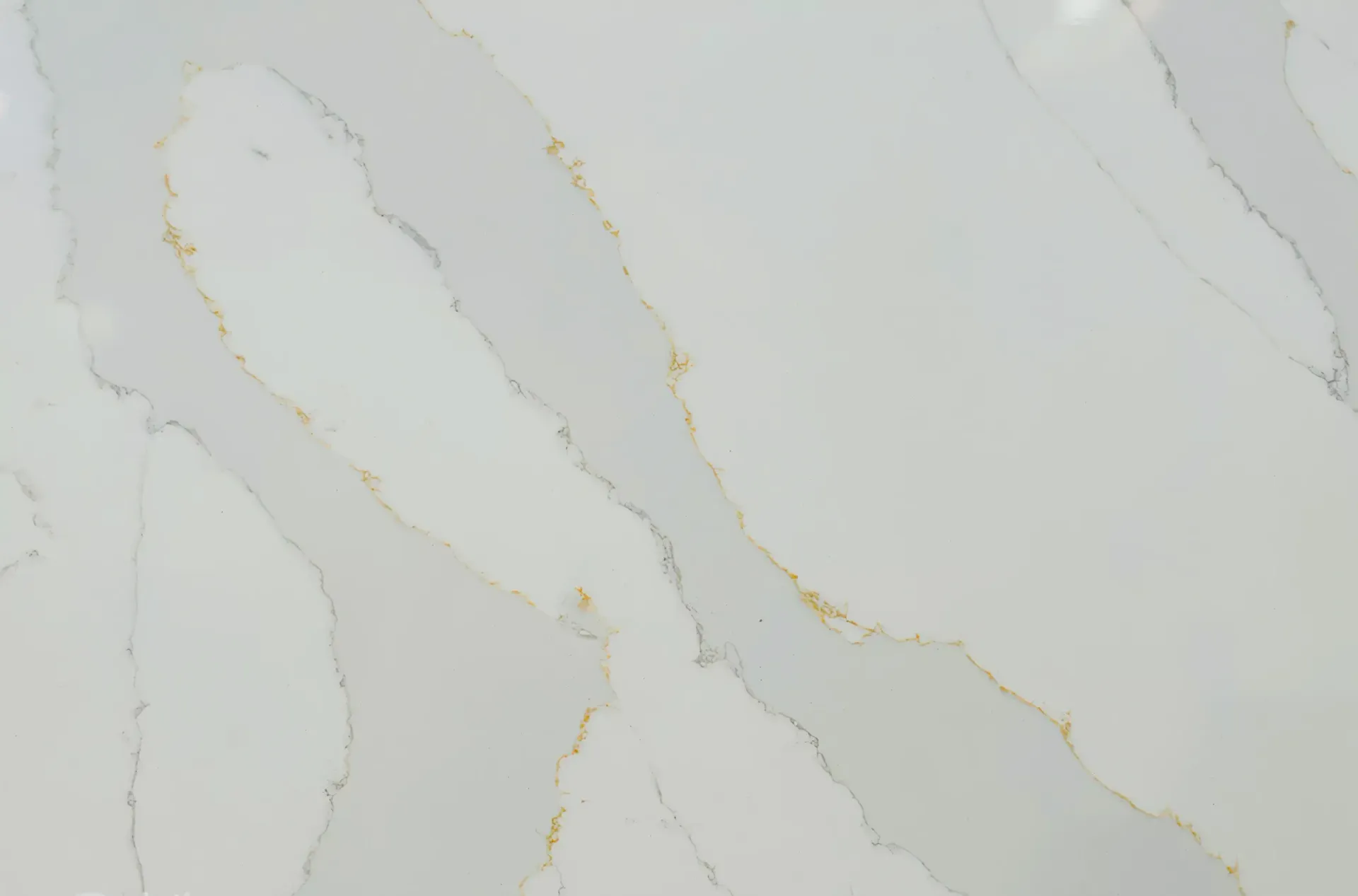 White quartz countertop with gray and gold veining.