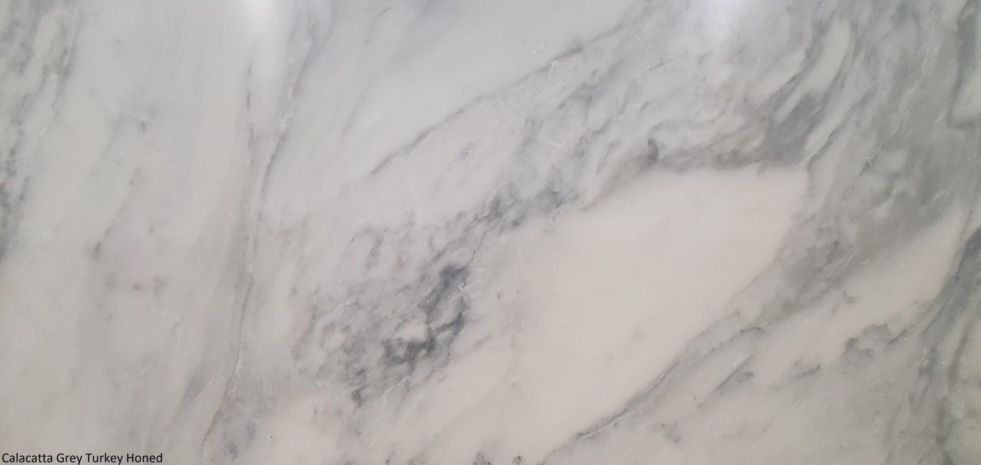 White marble surface with gray veining.