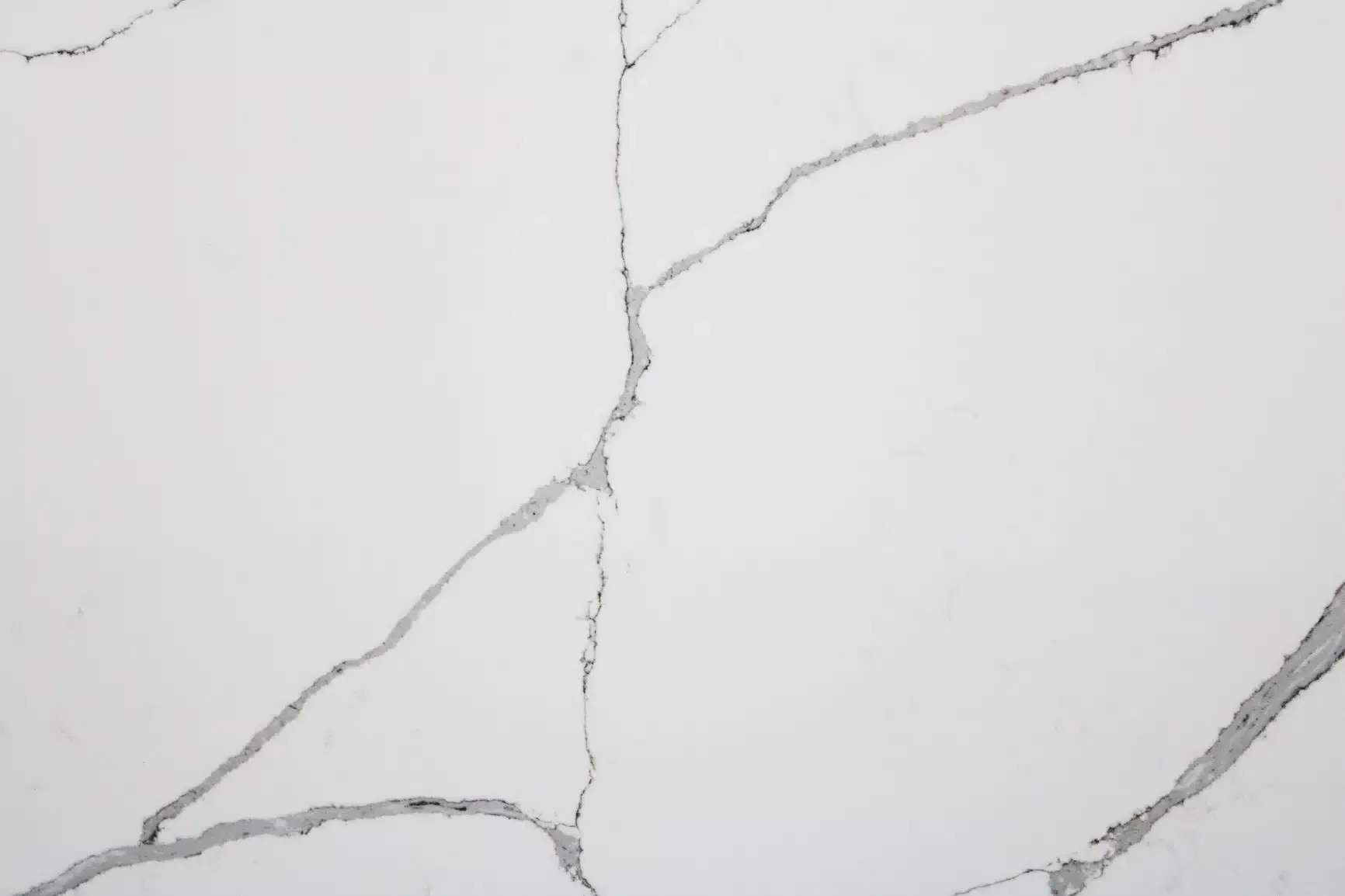 White surface with gray veining resembling marble.