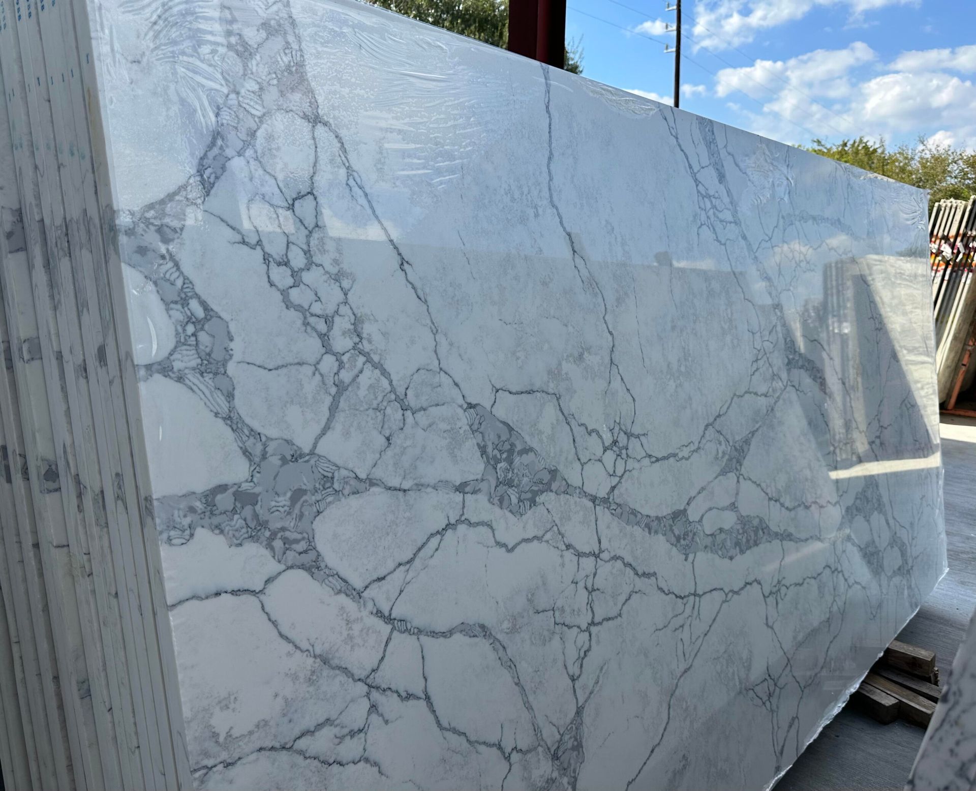 Large white stone slab with grey veining, outdoors.