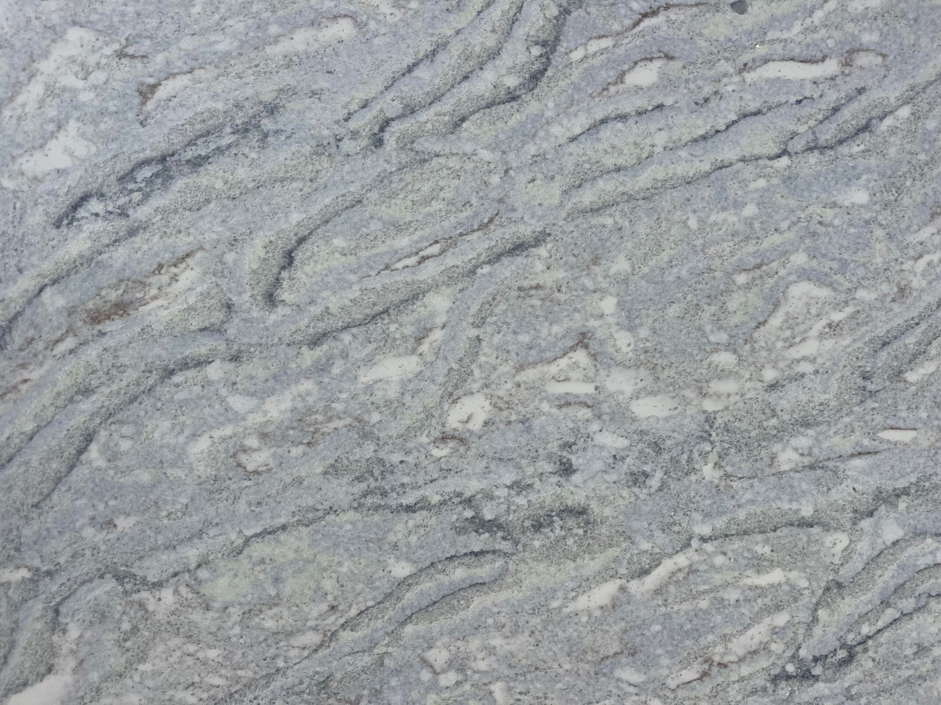 Gray and white granite countertop with wavy patterns.