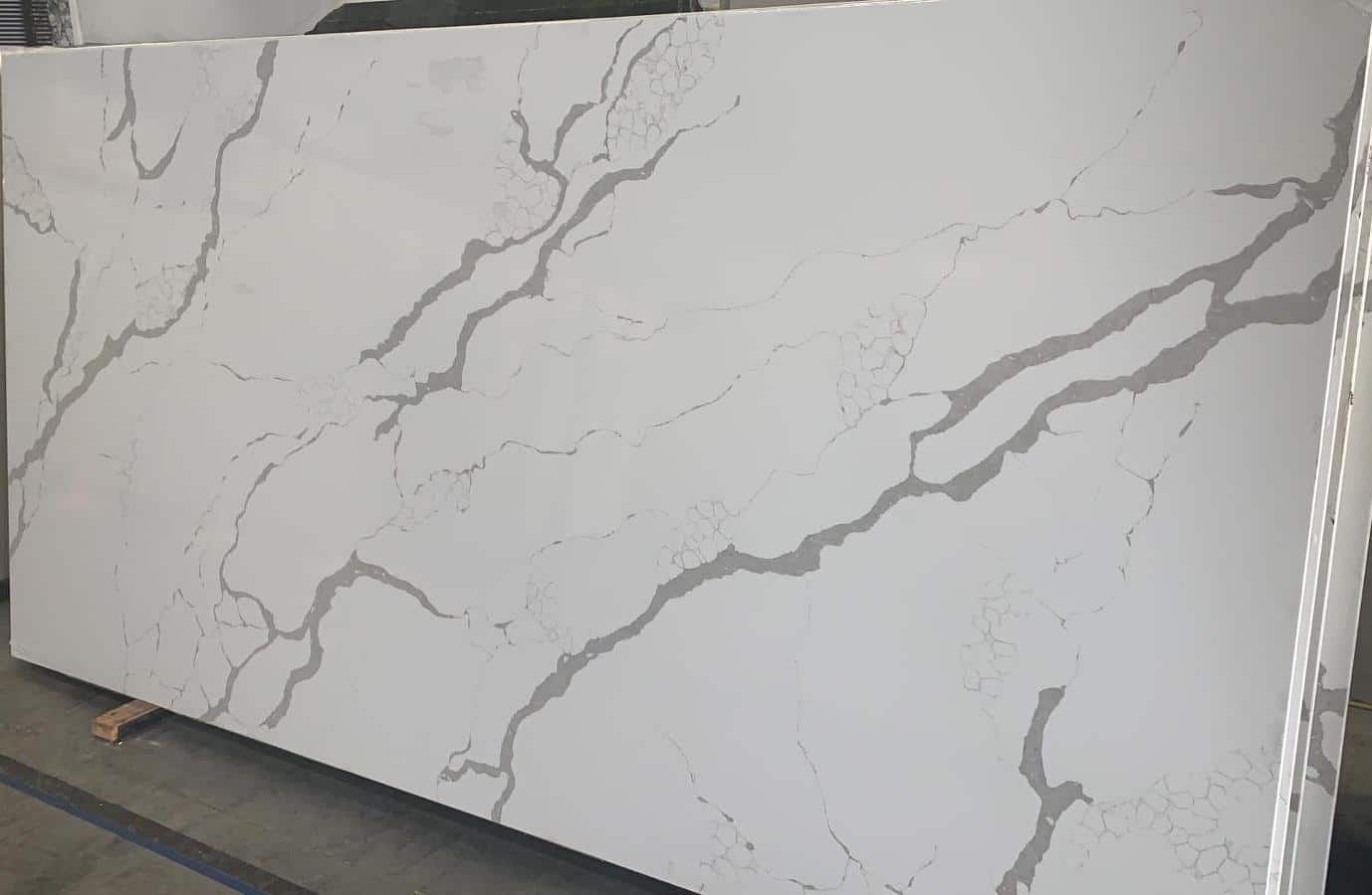Large white quartz slab with gray veining, likely for countertops.