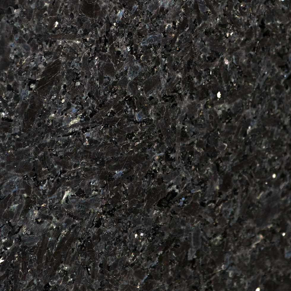 Close-up of a dark granite surface with flecks of silver and blue.