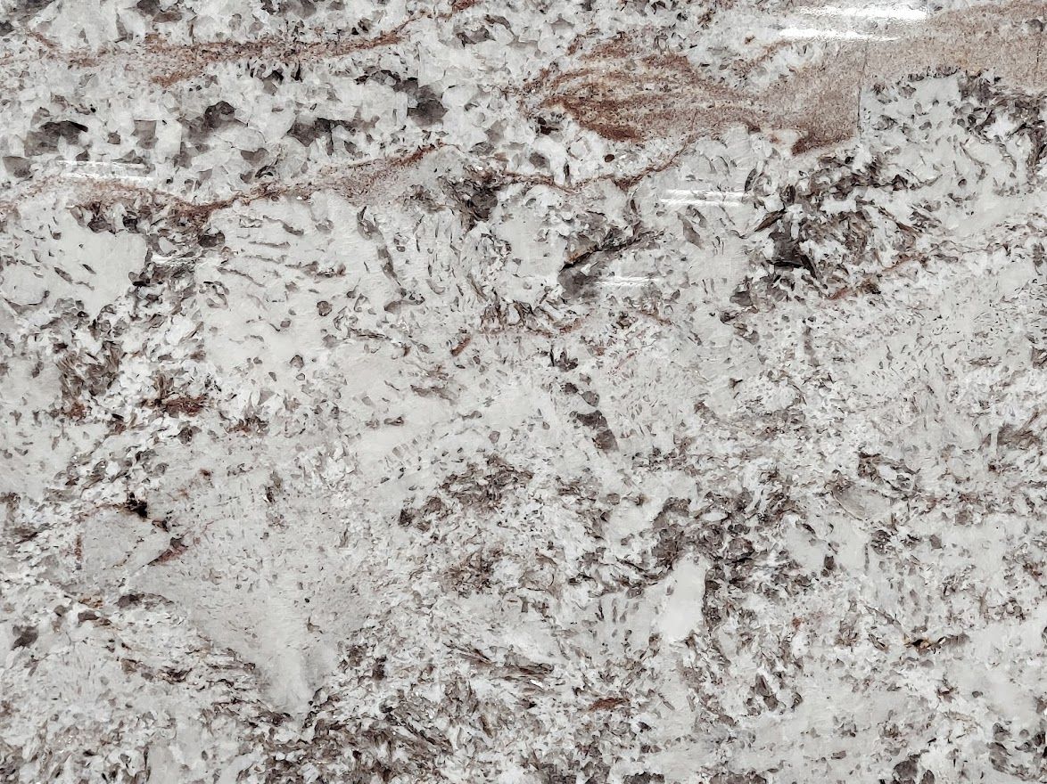 White granite countertop with brown and gray veining.