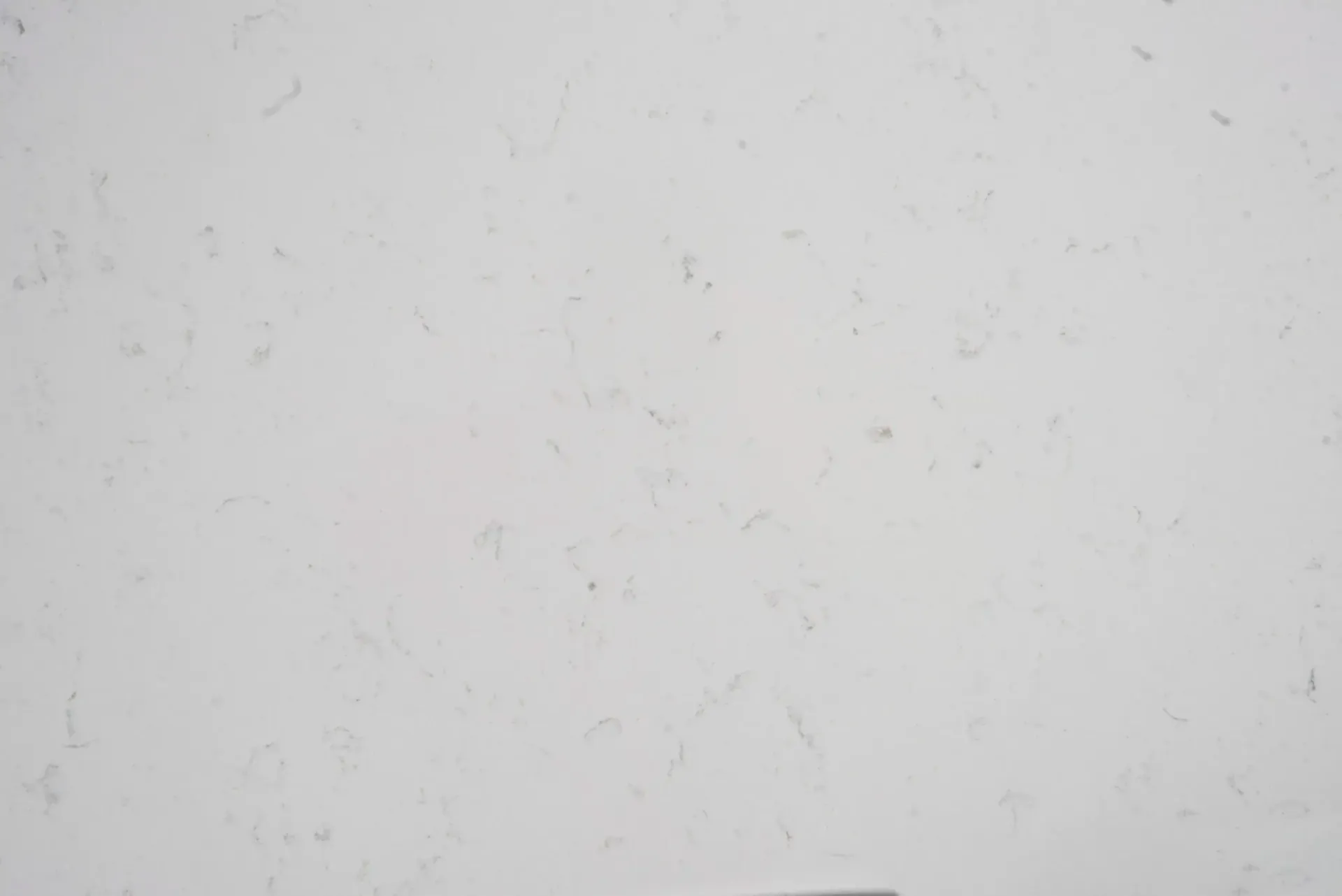 White quartz countertop with subtle gray veining.