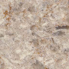 Beige and tan quartz countertop with speckled texture and some brown and gray inclusions.