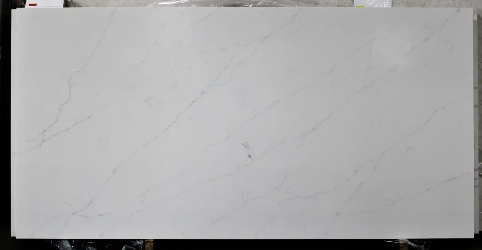 White quartz countertop slab with subtle gray veining.