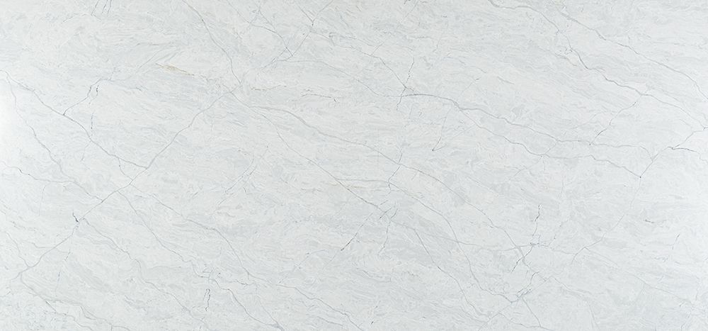 White stone surface with subtle veining and hairline cracks.