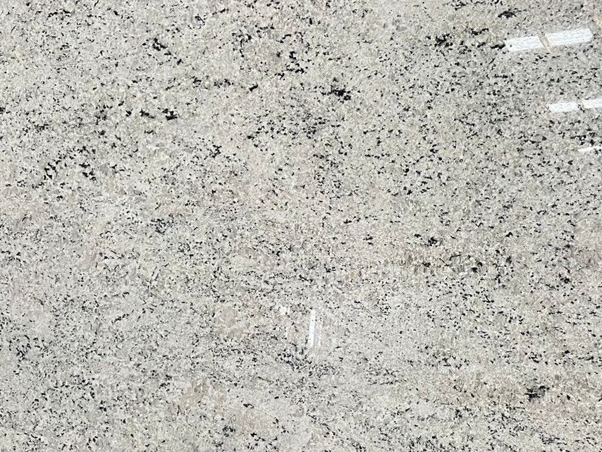 White granite countertop with black speckles and streaks.