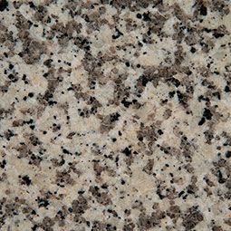 Beige granite surface with black and brown speckles.