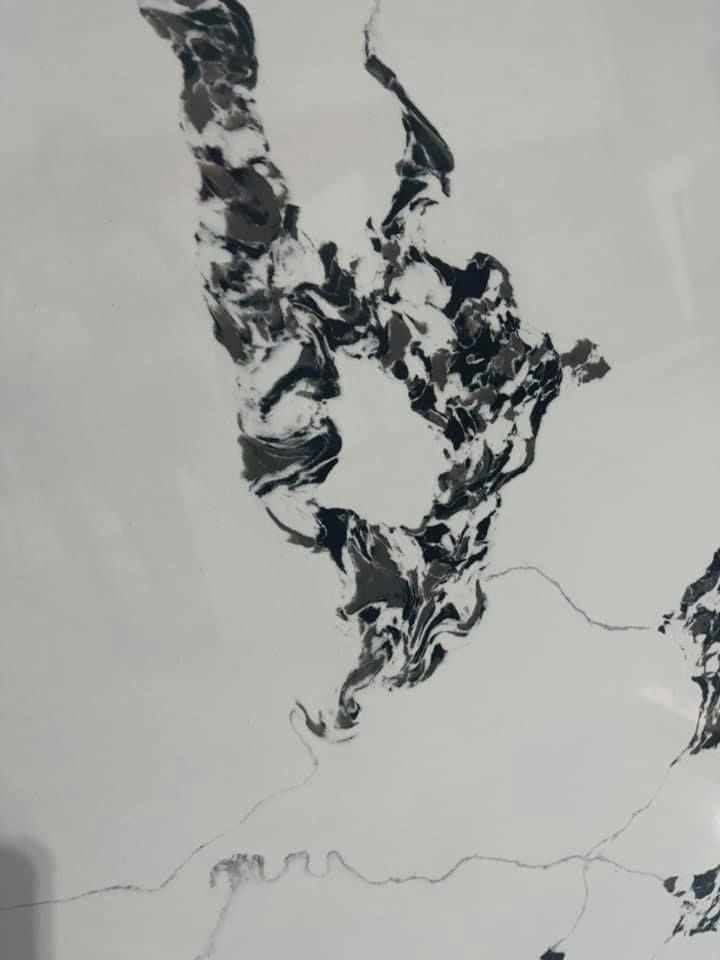 White surface with black and gray marbled pattern.