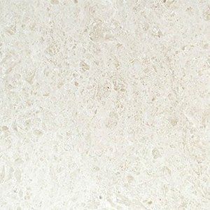 Cream-colored countertop with irregular, textured surface and light speckling.