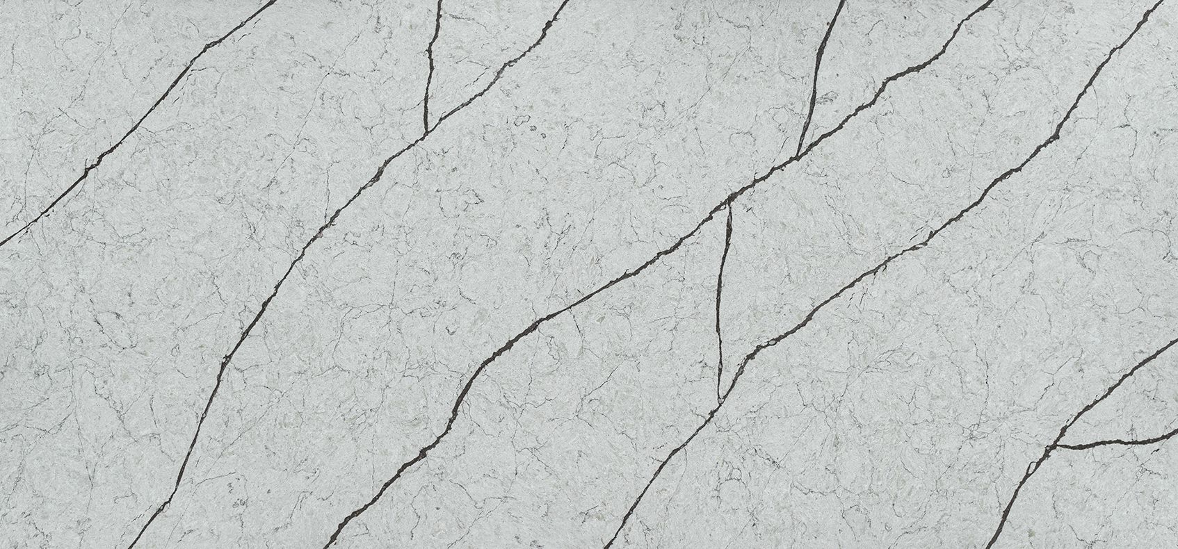 Gray textured surface with dark, jagged cracks.