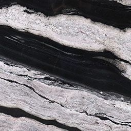 Close-up of a stone surface with flowing, black and white patterns.