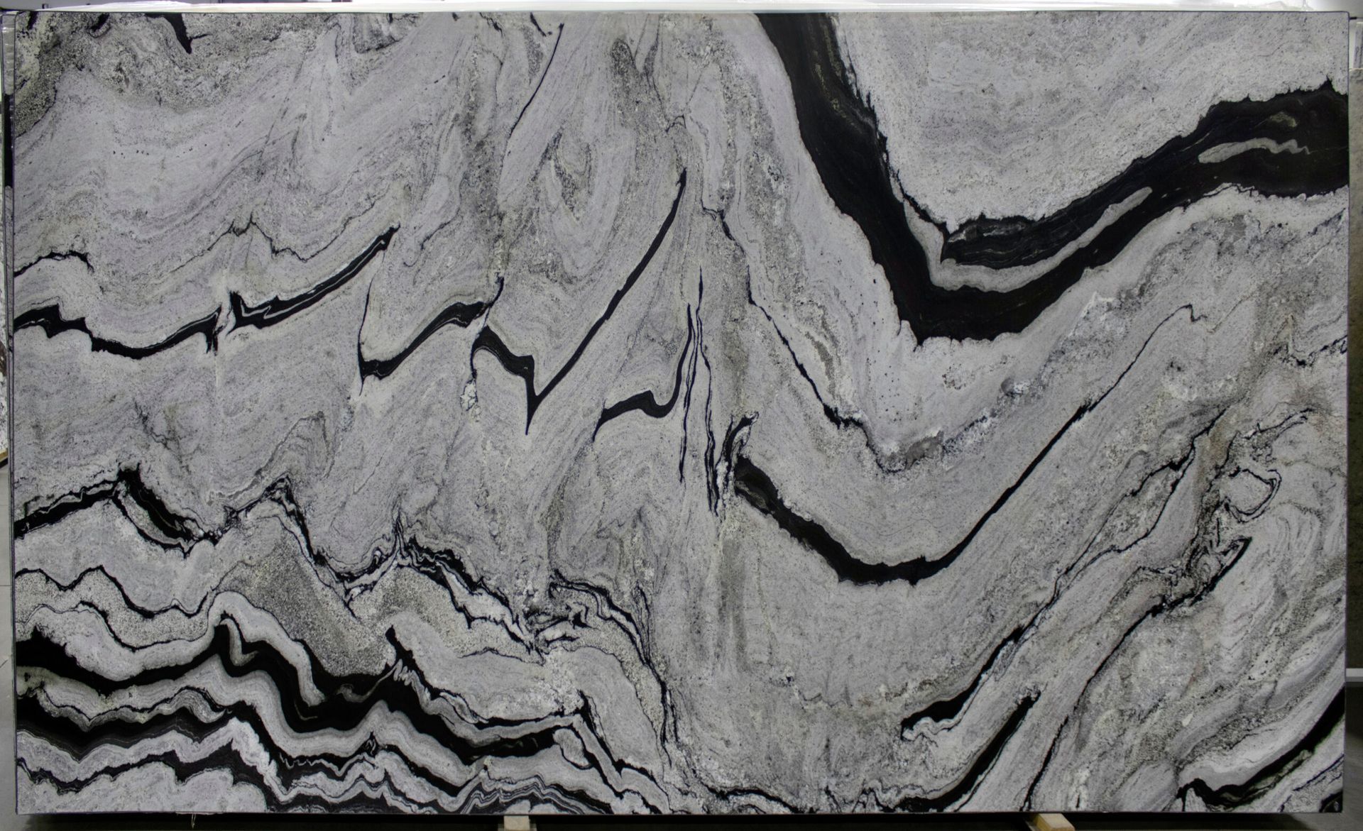 Large slab of granite with flowing gray and black wave patterns.