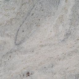 Close-up of a light gray granite countertop with subtle veining and speckles.