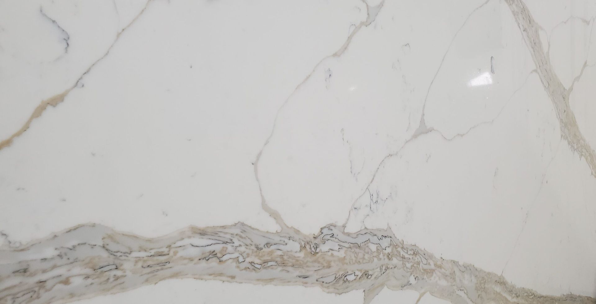 White marble slab with brown and gray veining.