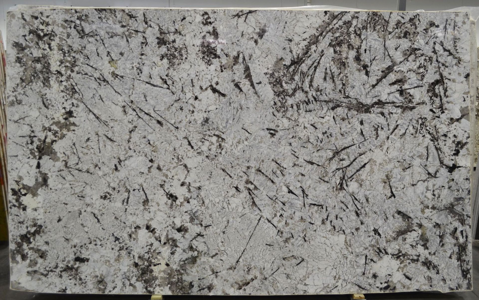 Granite slab with a white background, gray and brown veining pattern.