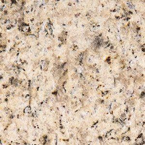 Close-up of a speckled beige granite surface with dark gray and black flecks.