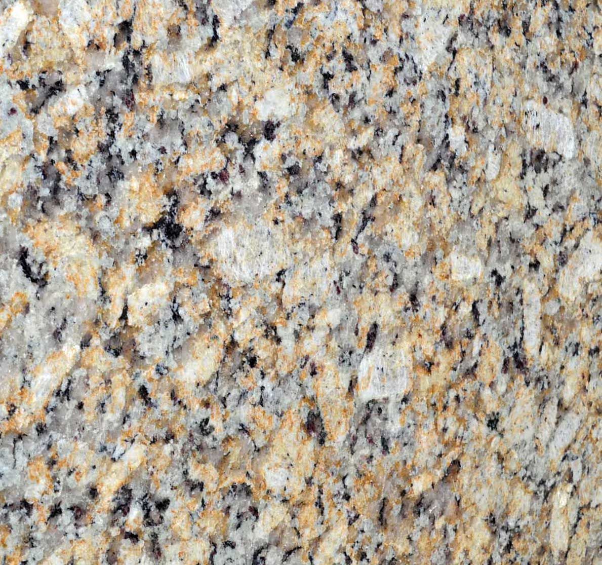 Close-up of granite surface with tan, gray, and black speckles.