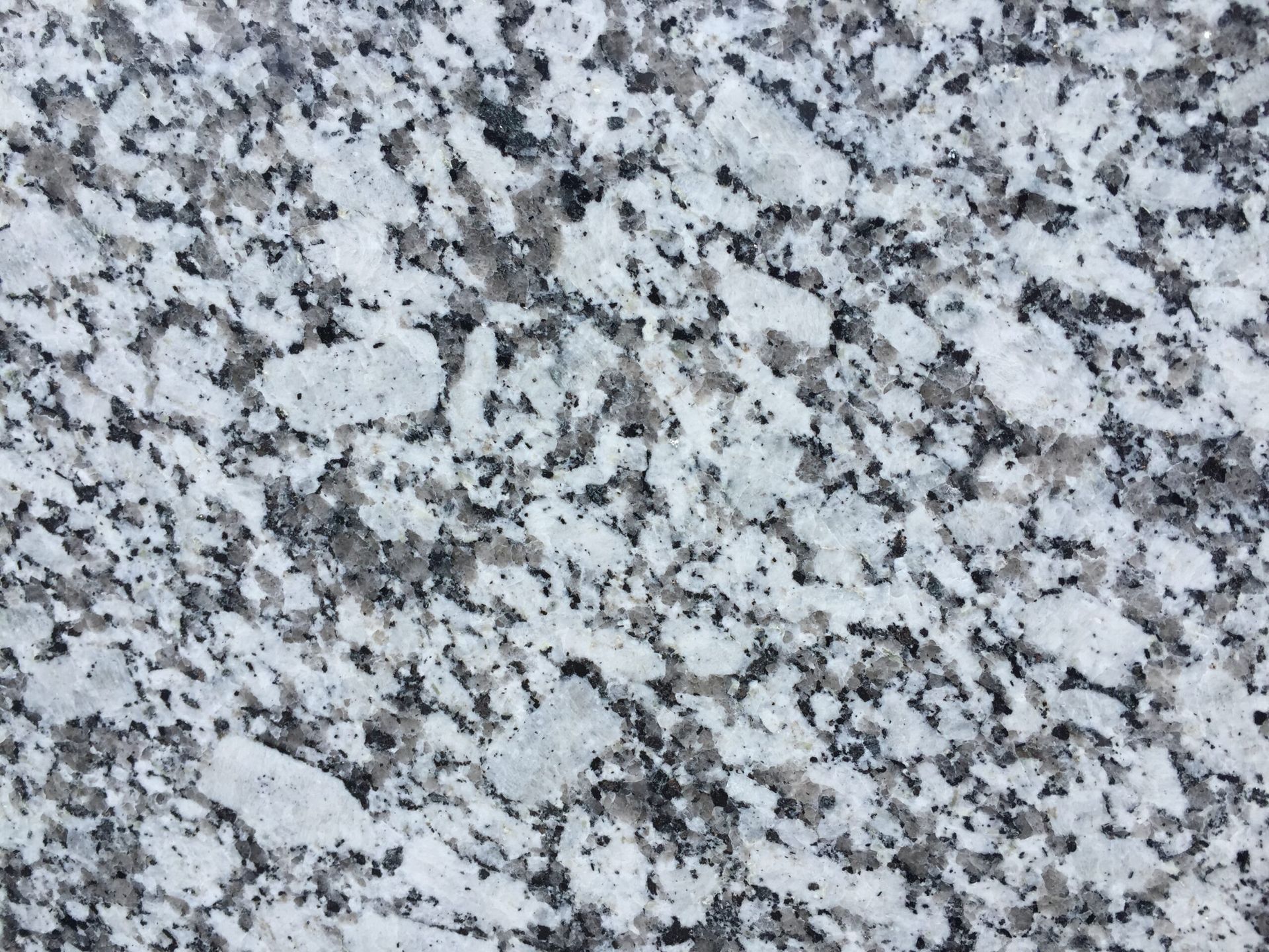 Close-up of white granite stone with gray and black speckles.
