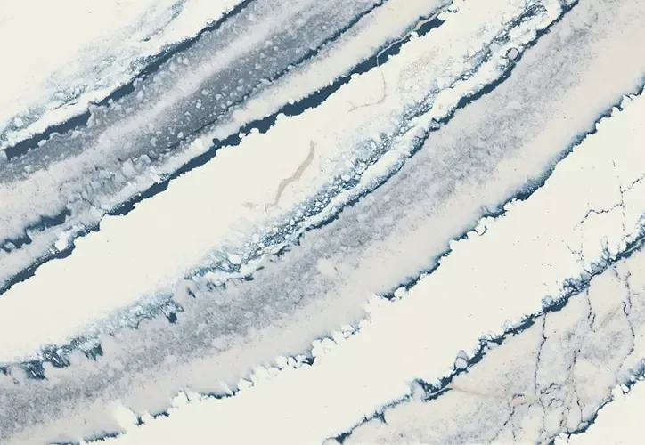 White countertop with diagonal blue-grey veining, resembling marble or stone.