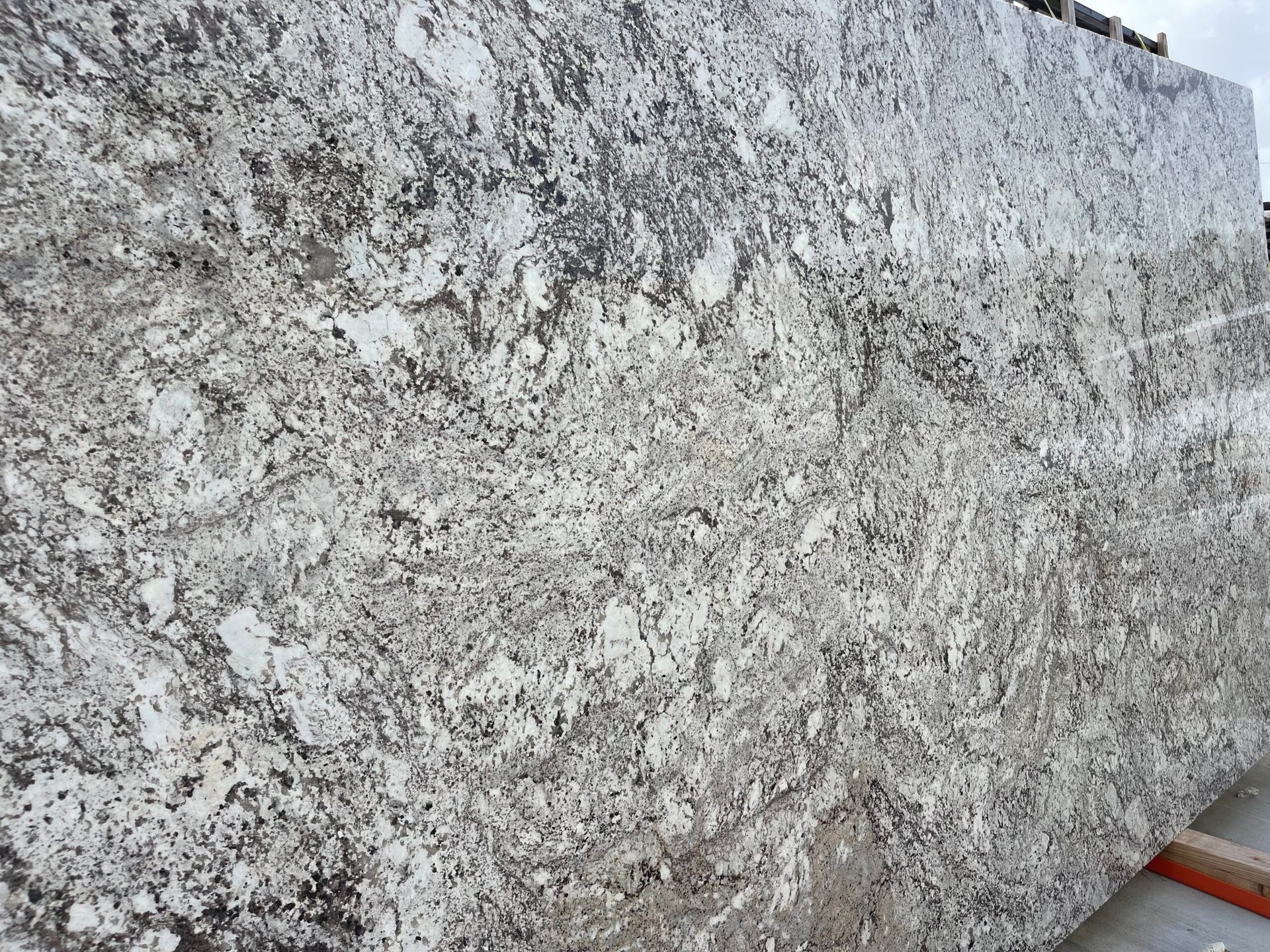 Granite slab with a mottled pattern of white, gray, and brown.